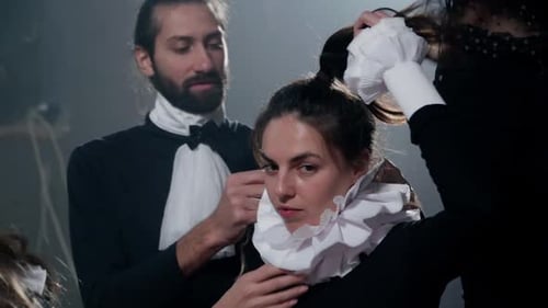 Costume Designers Adjusting Clothing on a Woman