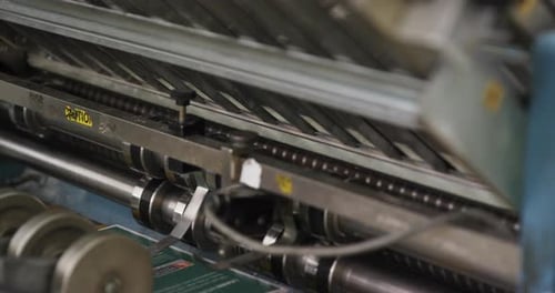 Custom Printed Pamphlets Coming Out Of An Offset Printing Machine. close up