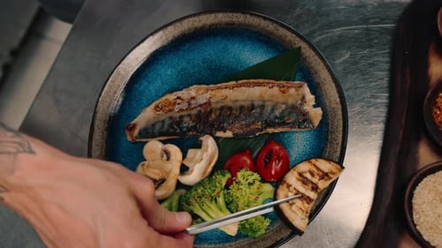 Grilled Fish and Vegetables Plated by a Chef