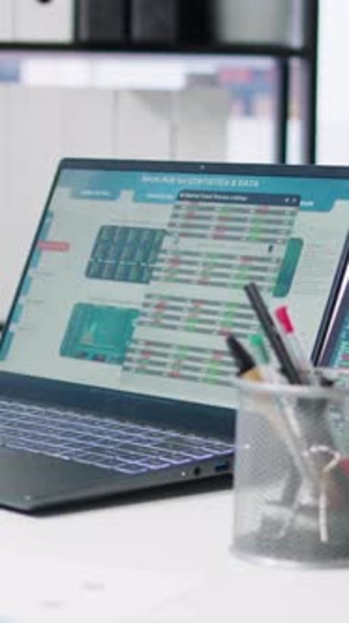 Vertical Video Stock Market Values Going Up and Down on Laptop in Empty Office