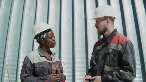 Factory Workers Talking between Work Outdoors