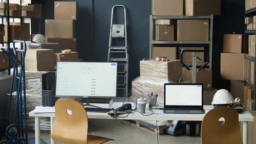 Empty Warehouse Office Desk with Computers and Logistics Software