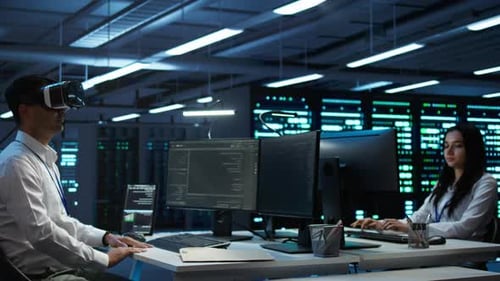 IT Worker Uses VR Headset for Server Maintenance in Server Farm During Network Monitoring