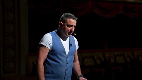 Actor on classic theatre stage. Man is speaking in spotlights during the performance.