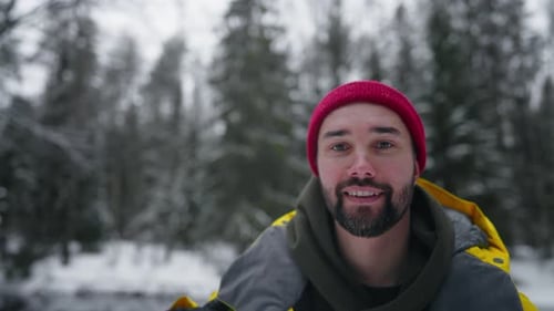 Portrait of Happy Bearded Caucasian Man Traveling Alone in Forest in Winter Joyful Tourist Smiling