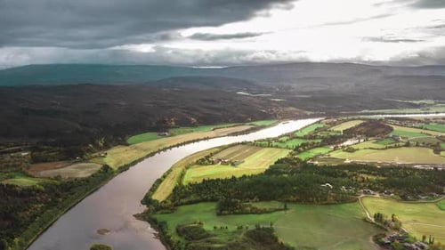 Aerial view of the Namsen river valley. The patchwork of the farm fields and forest stretching to th