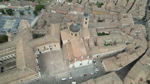 Aerial footage showcasing the intricate rooftops of an ancient Italian town Urbino, with a central s