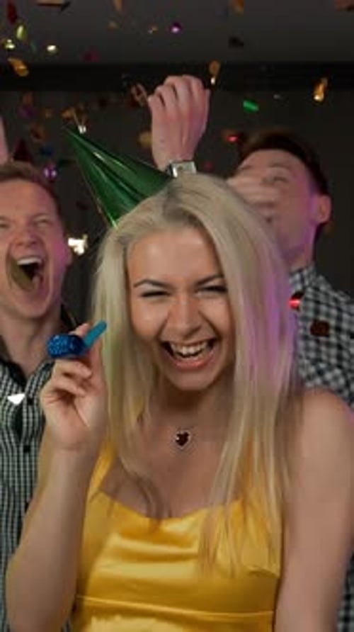 Enthusiastic Friends Celebrate Birthday with Confetti and Blowers