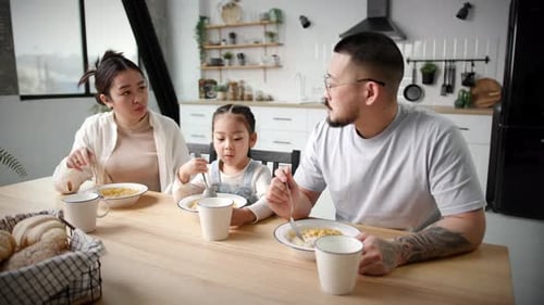 Family Having Breakfast Together at Kitchen Table