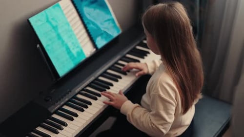 Young Girl Plays Electronic Piano at Home