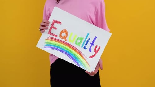 Gay Caucasian Man Holding a Protest Sign During a LGBT Pride Parade