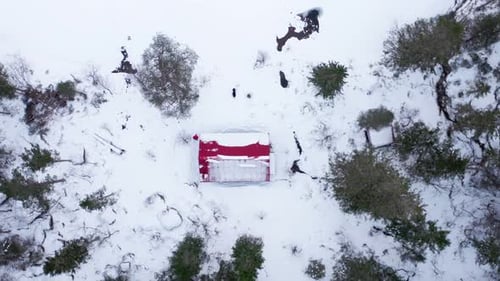 Drone Ascending On A Cabin In Winter Forest At The Mountains. Aerial Orbiting
