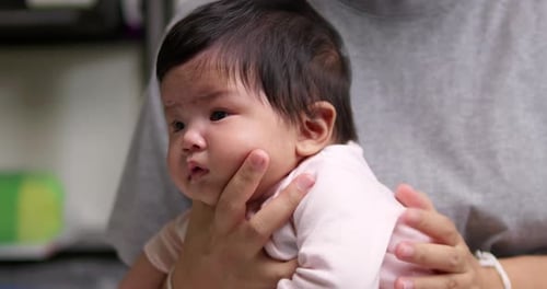 Baby Held by Adult Inside