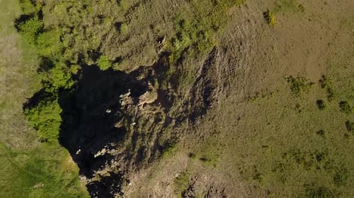 Aerial View of Man Coming Down the Mountain Male Hiking Down the Rocky Cliff Alone Climber in the