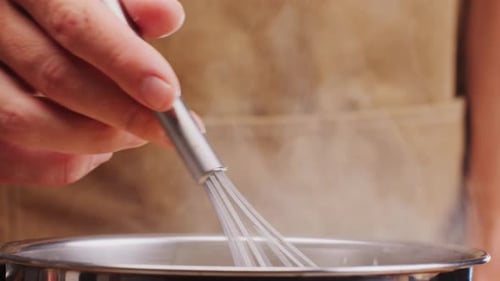 Close Up of Cooking with Whisk in Pot