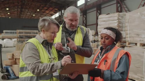 Two Storage Office Workers Bringing New Employee up to Date