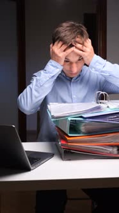 Vertical Video Man Experiencing Burnout with Overwhelming Office Paperwork Workload