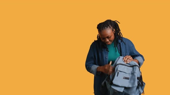 Joyous Woman Rummaging Through Backpack for School Notebooks Studio ...