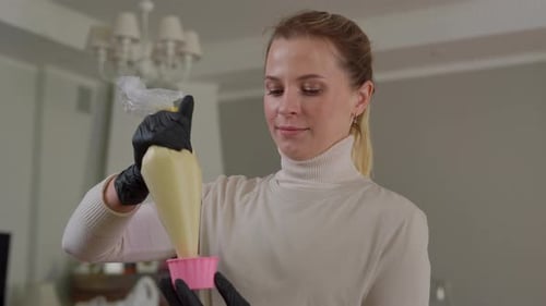 Woman Fills Cupcake Liners With Batter at Home