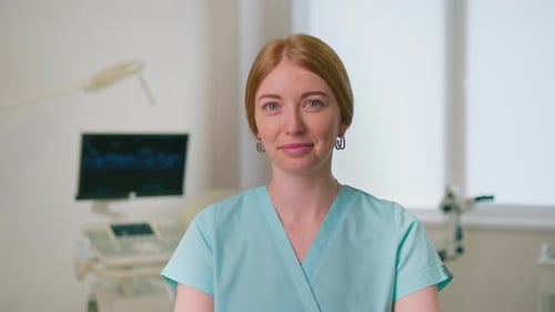 smiling gynecologist doctor in gynecological office near ultrasound and gynecological chair waiting