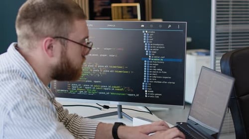 Bearded Programmer Working On Laptop