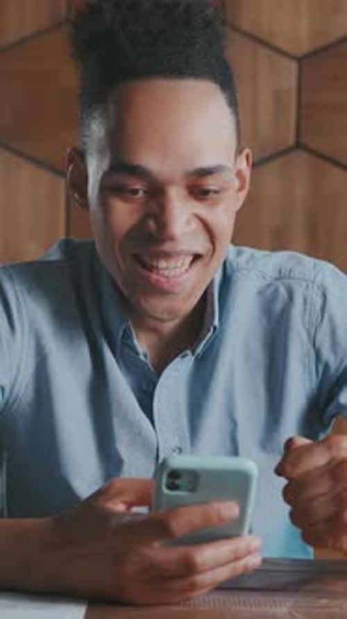 Excited Man Reacting to Good News on Phone