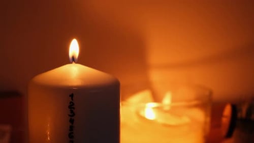 Burning Candles in Warm, Dark Room at Night