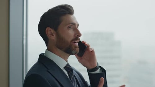 Smiling Businessman Phone Deal in Modern Office
