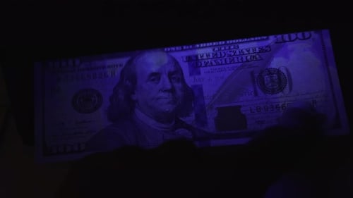 One Hundred Dollar Bill Under Ultraviolet Light