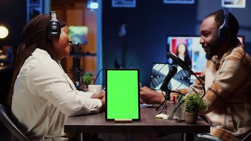 Chroma Key Tablet Next to Talking Show Interviewer Telling Jokes to Audience Watching at Home