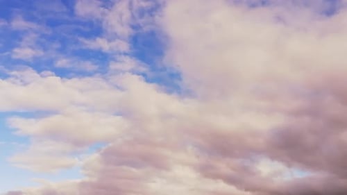 Fluffy Clouds Drifting Across a Bright Blue Sky