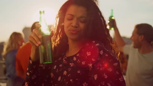 Woman Dancing and Celebrating with Friends on Rooftop