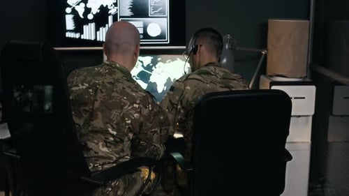 Adults Monitoring Computers in Operation Center