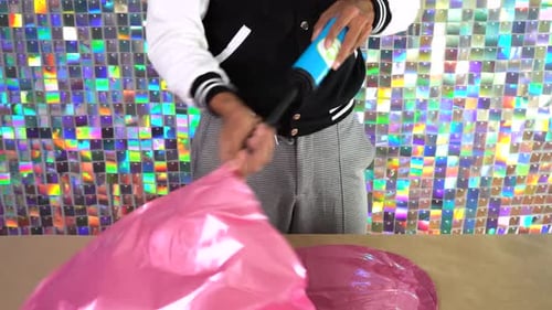 Inflating a Pink Heart Balloon for Party