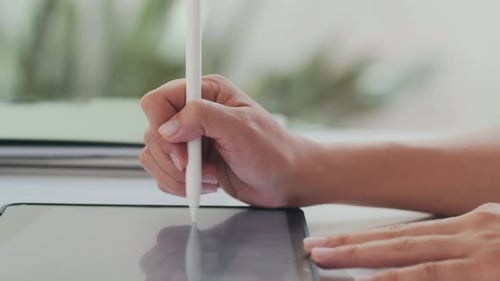 Woman's Hands Drawing on Tablet with Stylus