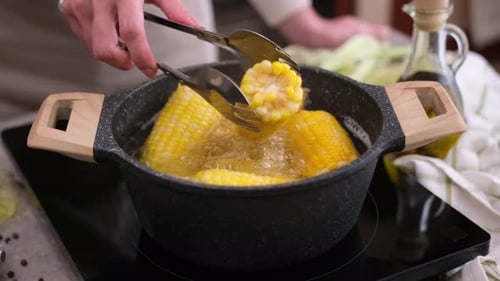 Bright Yellow Corn Boiling on the Cob