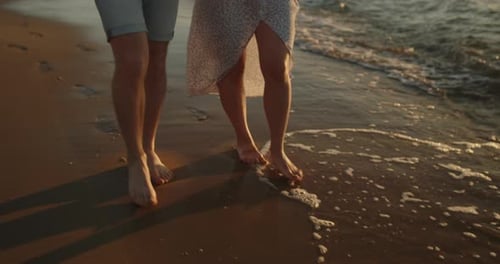 Young Loving Couple Enjoying Relaxing Sunset Walk on the Beach