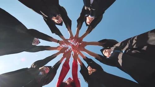 Graduates Joining Hands to Celebrate Graduation