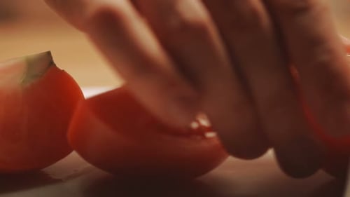 Cutting Up a Tomato with a Knife. Cooking Closeup. Chopping Tomatoes On