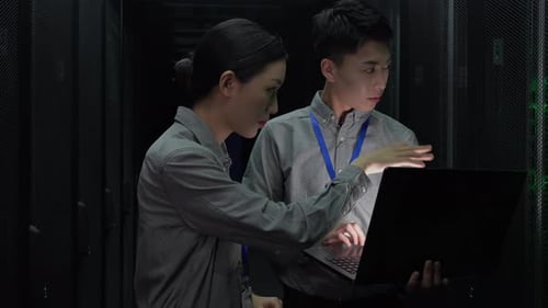 Two IT Technicians Working in Data Center