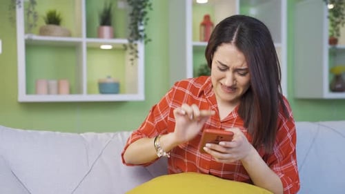 Frustrated Woman Typing on Phone in Living Room