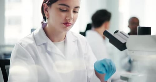 Woman Using Microscope in Modern Laboratory