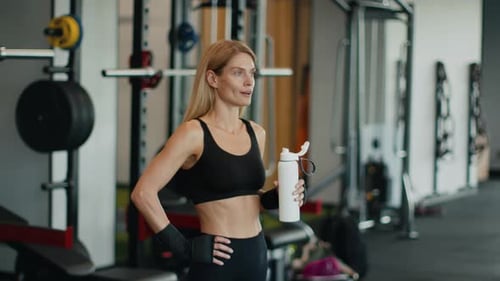 Woman Drinking Water after Gym Workout