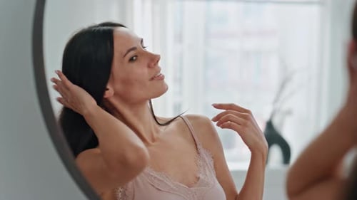 Woman Posing in Front of Round Mirror
