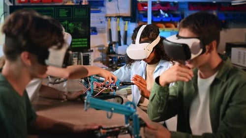Group of young people in VR glasses doing experiments in robotics in a laboratory. Robots on the tab