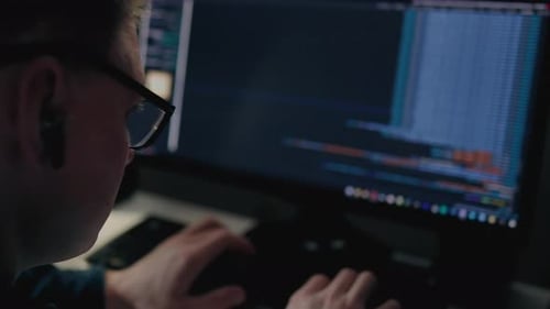 Programmer Working on Computer in Dark Room