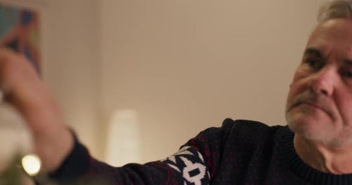 Silver Haired Man Contemplating Christmas Indoors