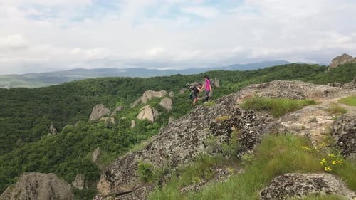 Young Adults Hiking Rocky Mountain Helping Each Other