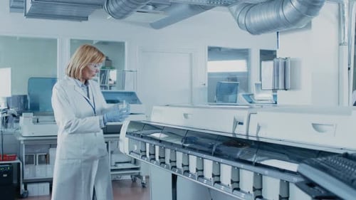 Scientist Working in Laboratory with Automated Machines