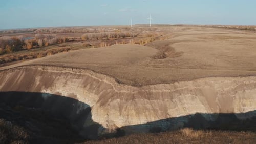 Picturesque Rural Landscape with Cliffs and Wind Turbines